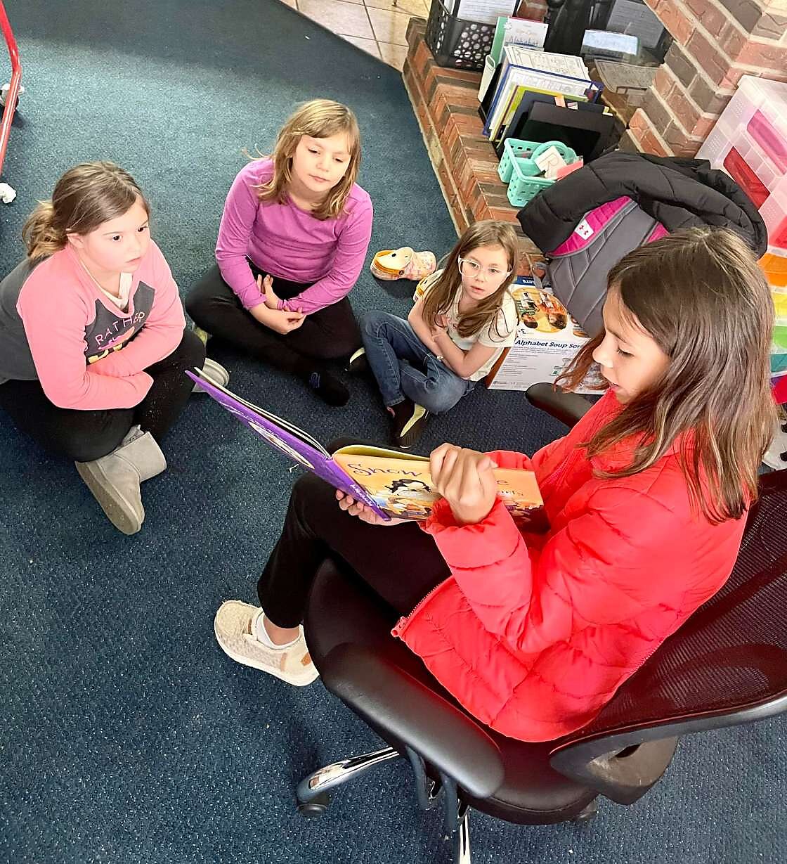 Multi-age learning: older kids read to younger kids at Riverside.